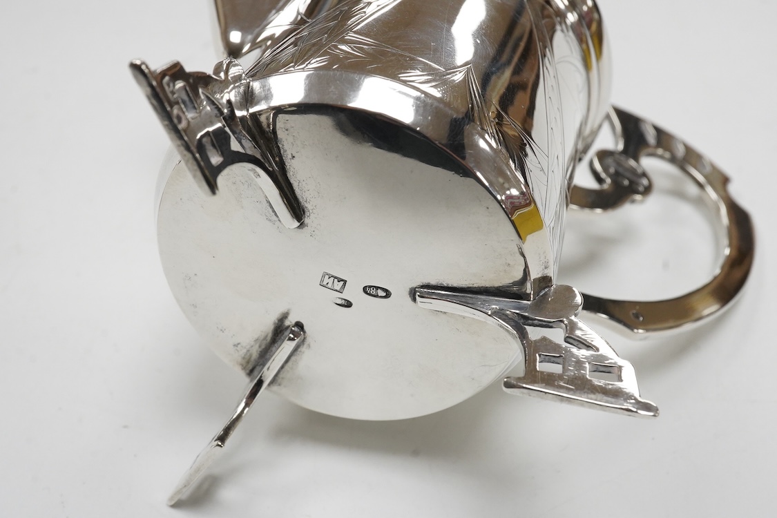 A late 19th/early 20th century Russian 84 zolotnik cream jug, with engraved decoration and angular feet and handle, master Andrei Ivanov, 1908-1917 kokoshnik mark, height 11.6cm, together with a similar single handled sm